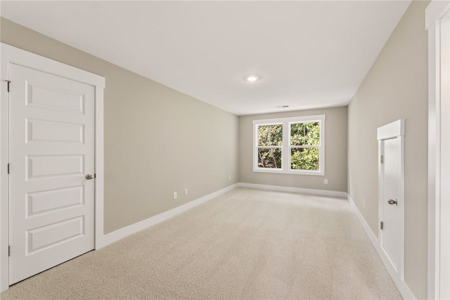 A spacious, naturally illuminated room features pl