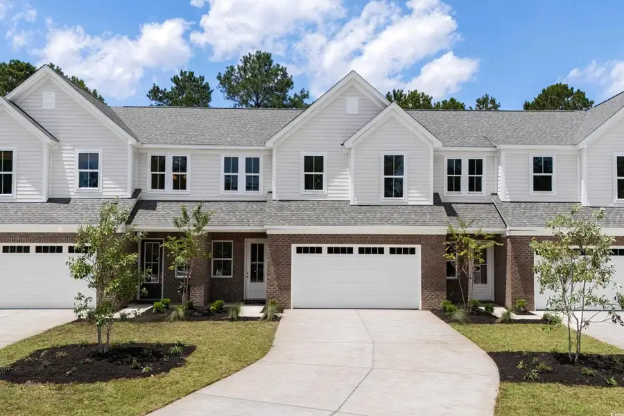 Front exterior of a new home in Long Bay Golf Club, Longs, SC, highlighting curb appeal (Image 1). Front exterior of a new home in Long Bay Golf Club, Longs, SC, highlighting curb appeal (Image 1).