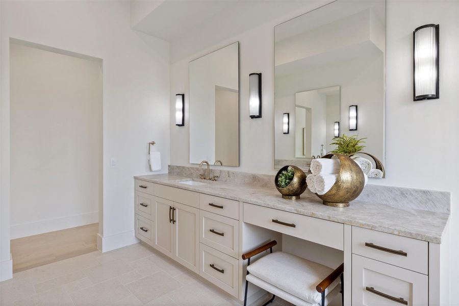 Bathroom featuring baseboards and vanity Bathroom featuring baseboards and vanity