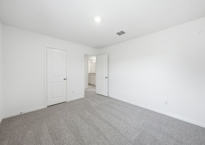 Carpeted Bedroom 4 featuring a closet doorway. Carpeted Bedroom 4 featuring a closet doorway.