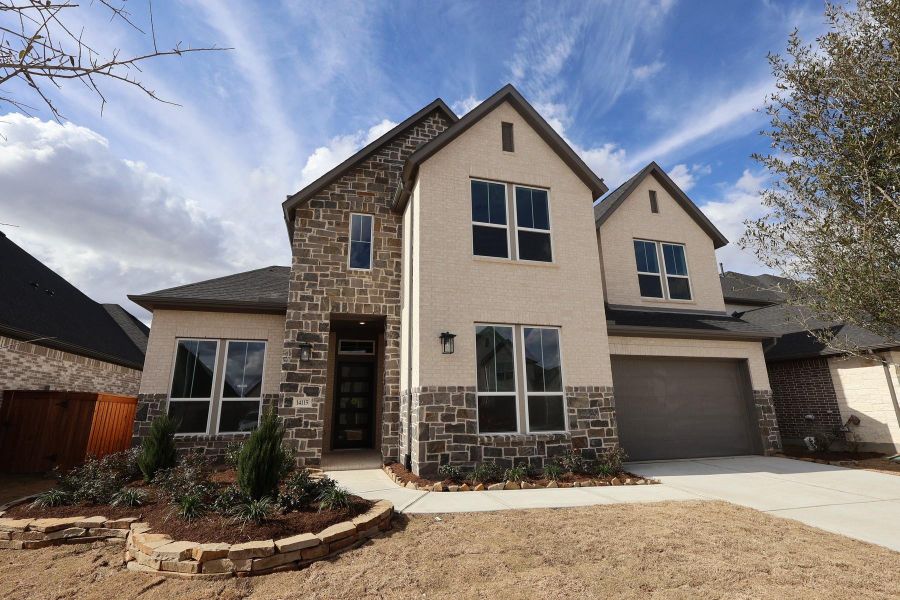 Front exterior of a new home in Dunham Pointe, Cypress, TX, highlighting curb appeal (Image 20). Front exterior of a new home in Dunham Pointe, Cypress, TX, highlighting curb appeal (Image 20).