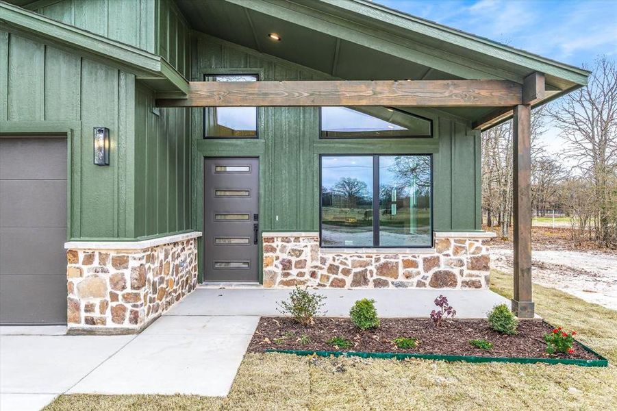 Accent cedar, natural stone, and intentional landscape!