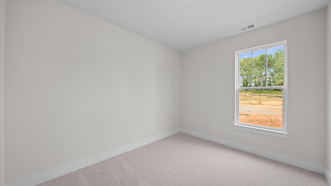 Superior comfort in this light-filled bedroom with plush carpeting and thoughtfully placed large windows