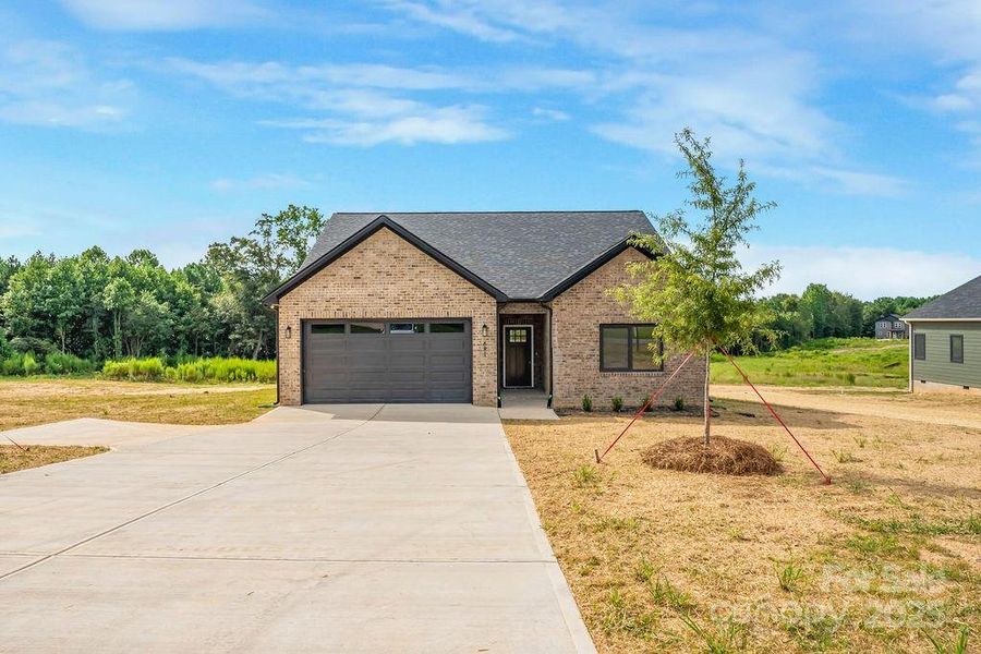 Front exterior of a new home in , Lincolnton, NC, highlighting curb appeal (Image 1).