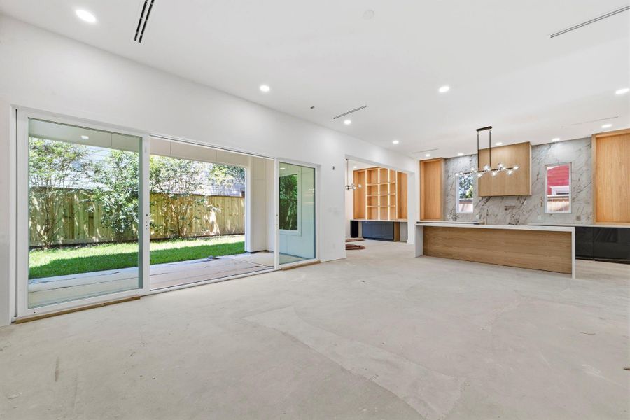 This photo highlights the first-floor living area and the backyard offers ample space for a pool. This photo highlights the first-floor living area and the backyard offers ample space for a pool.
