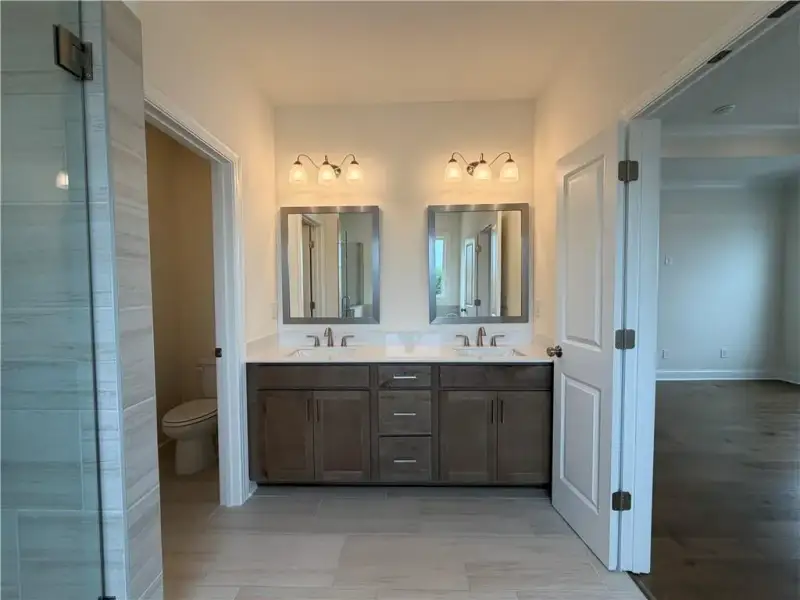 Dual Vanity with Quartz Tops & Framed Mirrors *Images shown are from a different homesite featuring the Aspen Floor Plan. Design selections and colors will vary by home. *