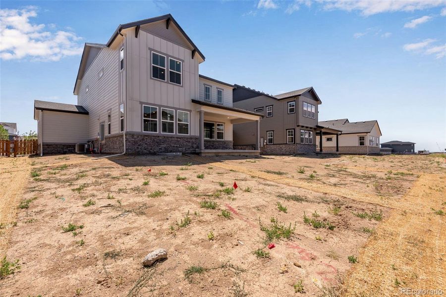Front exterior of a new home in Prelude at The Aurora Highlands, Aurora, CO, highlighting curb appeal (Image 22). Front exterior of a new home in Prelude at The Aurora Highlands, Aurora, CO, highlighting curb appeal (Image 22).