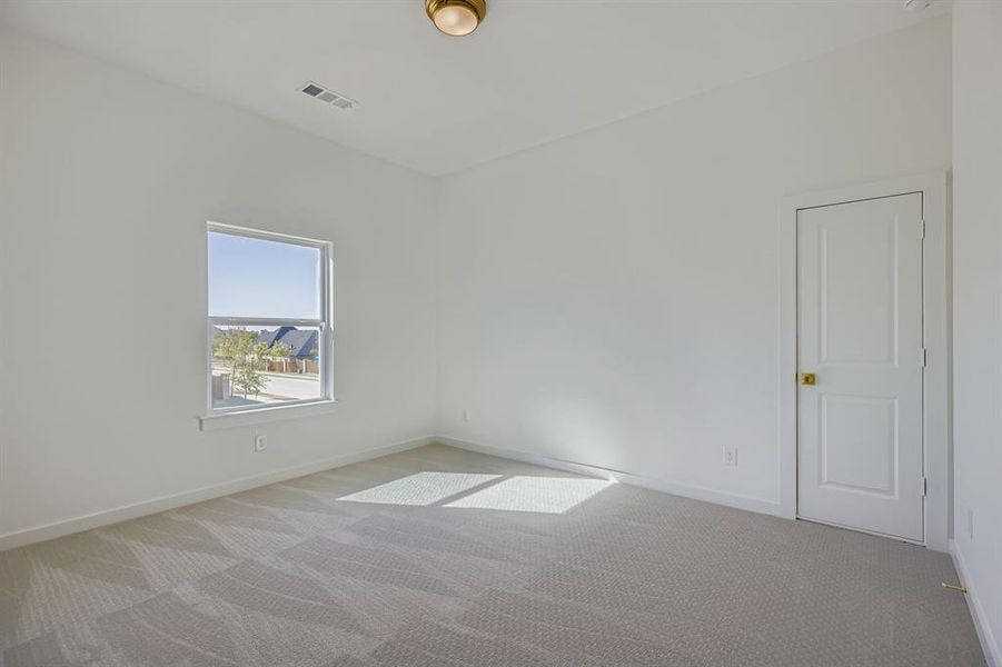 Unfurnished room with carpet and baseboards Unfurnished room with carpet and baseboards