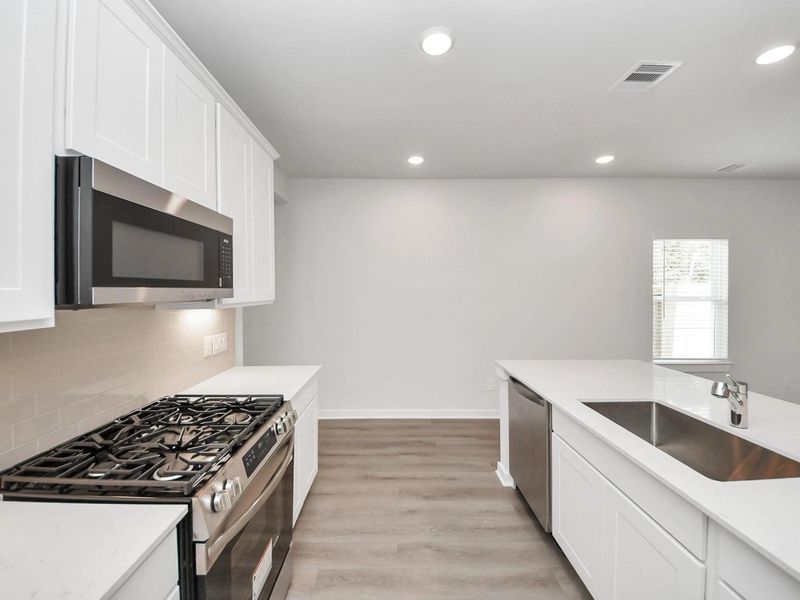 Furnished interior view inside a new home in Caney Creek Place, Conroe (Image 11).