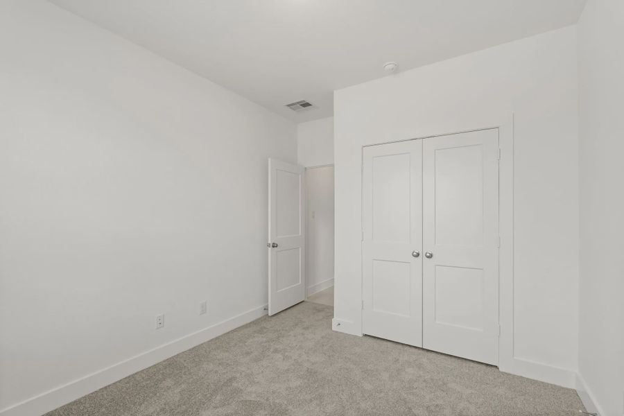 Representative unfurnished interior of a home built from the Chalet by Chesmar Homes in Meridiana Townhomes, Iowa Colony (Image 37).