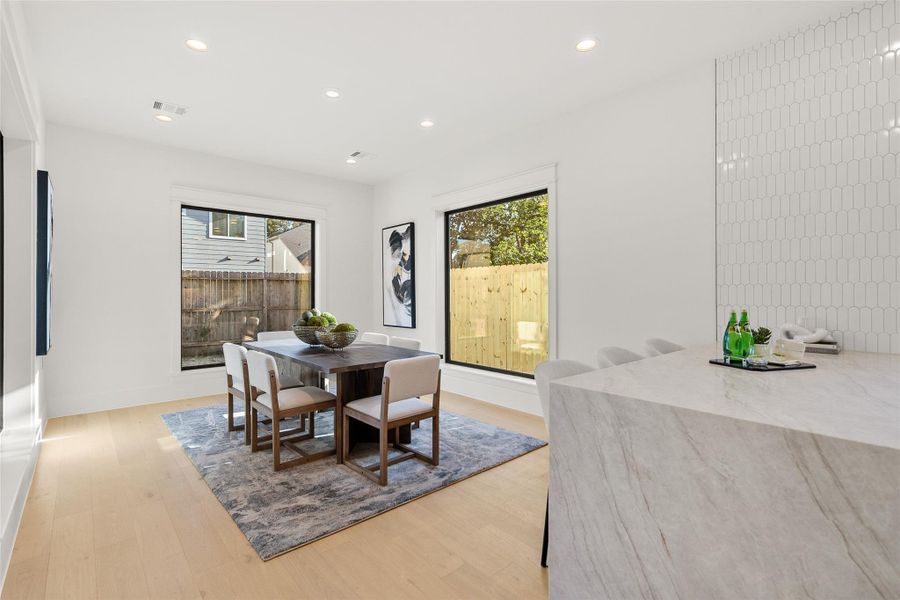 Casual meals feel bright and inviting in your sunlit dining area, surrounded by oversized windows that bring the outdoors in.