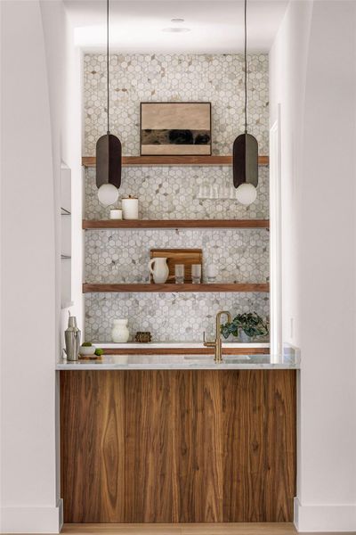 An inviting dining room features natural wood flooring, grand windows, and recessed lighting.