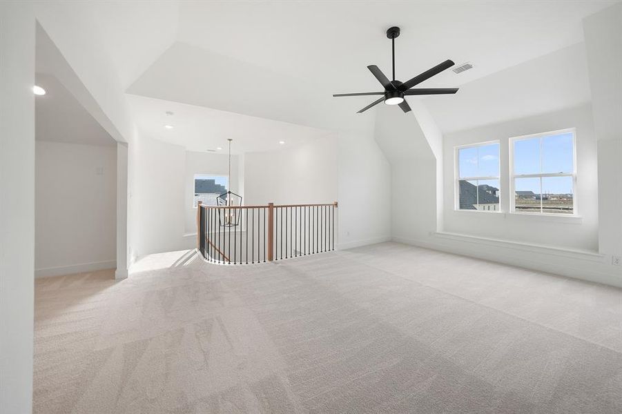 Bonus room featuring vaulted ceiling, healthy amount of natural light, carpet floors, ceiling fan, and recessed lighting
