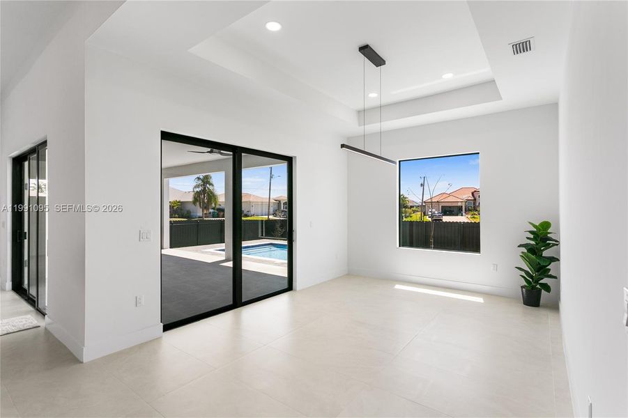 The FORMAL DINING AREA showcases STACKING SLIDERS to the lanai, blending INDOOR-OUTDOOR LIVING! The FORMAL DINING AREA showcases STACKING SLIDERS to the lanai, blending INDOOR-OUTDOOR LIVING!
