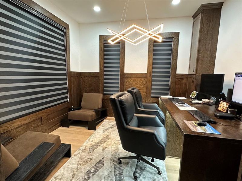 Office space featuring light wood finished floors, wainscoting, recessed lighting, and wooden walls