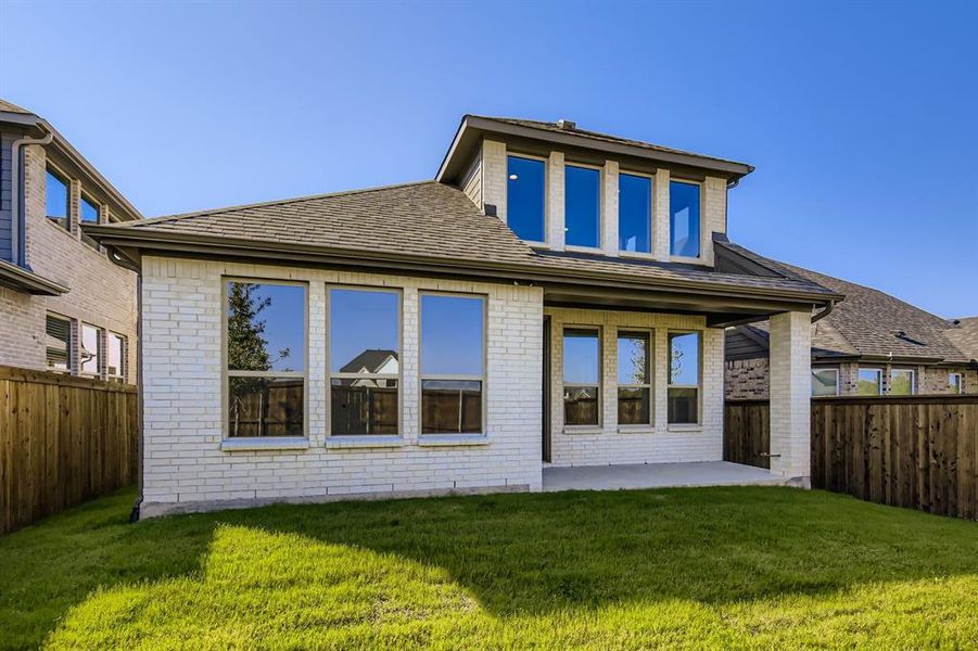 Rear view of property with brick siding, a patio area, a fenced backyard, and roof with shingles Rear view of property with brick siding, a patio area, a fenced backyard, and roof with shingles