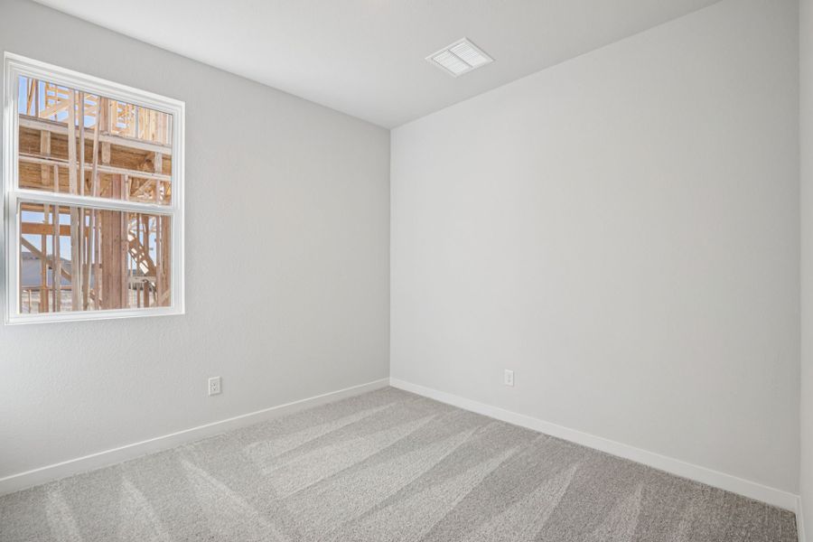 A room with a window and a rug. A room with a window and a rug.