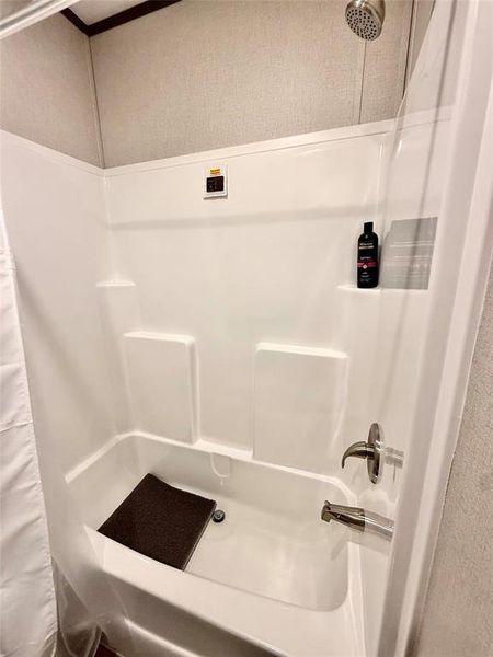 Bathroom featuring a shower with shower curtain