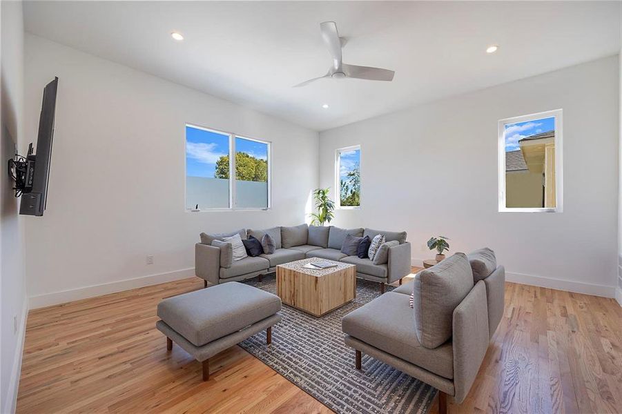 Living room featuring ceiling fan and light hardwood / wood-style floors