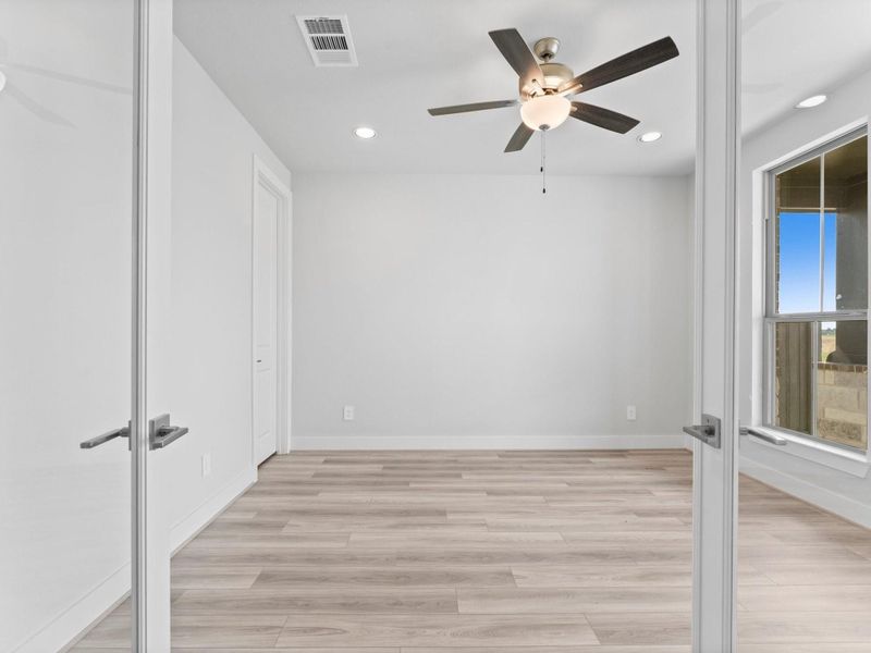 Double Doors Open to the Home/Office Study with Large Window, LVP Flooring, and Storage Closet. Double Doors Open to the Home/Office Study with Large Window, LVP Flooring, and Storage Closet.