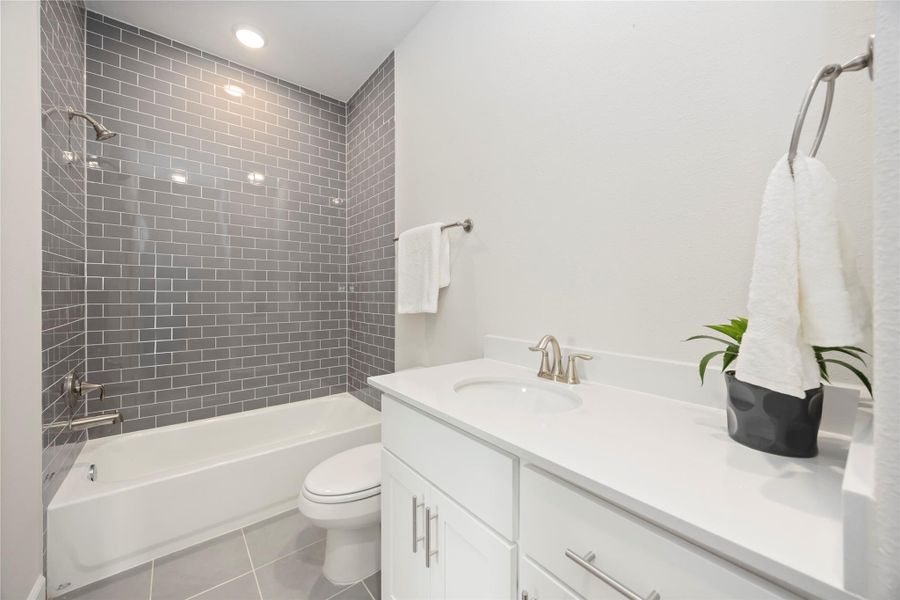 Timeless design and neutral finishes converge in the hall bathroom, crafting an elegant space for daily routines.