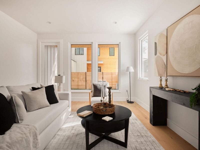 Living area with light wood-style floors and baseboards Living area with light wood-style floors and baseboards