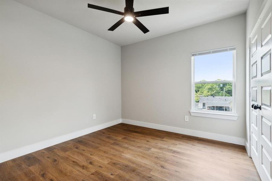 Spare room featuring ceiling fan and hardwood / wood-style floors