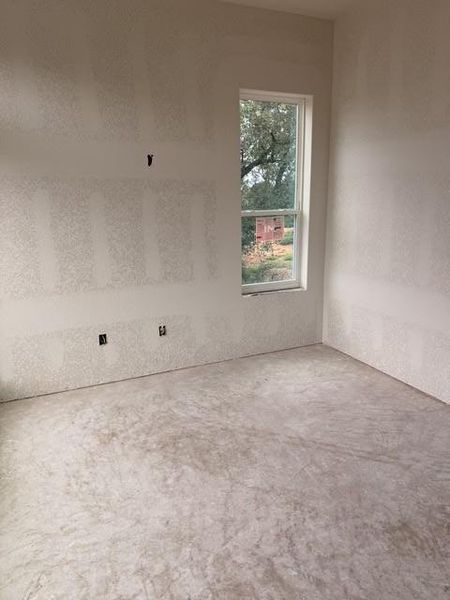 Bright interior space featuring a large window, providing natural illumination