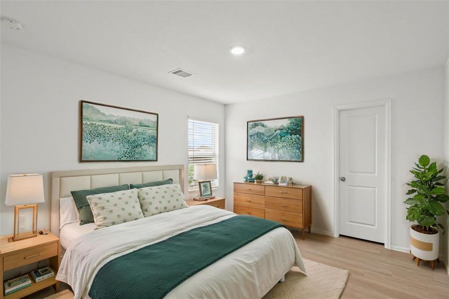 What a wonderful place to come home to! This spacious bedroom includes a large walk-in closet, wood like flooring, recessed lighting, and bright natural light. *This room has been virtually staged