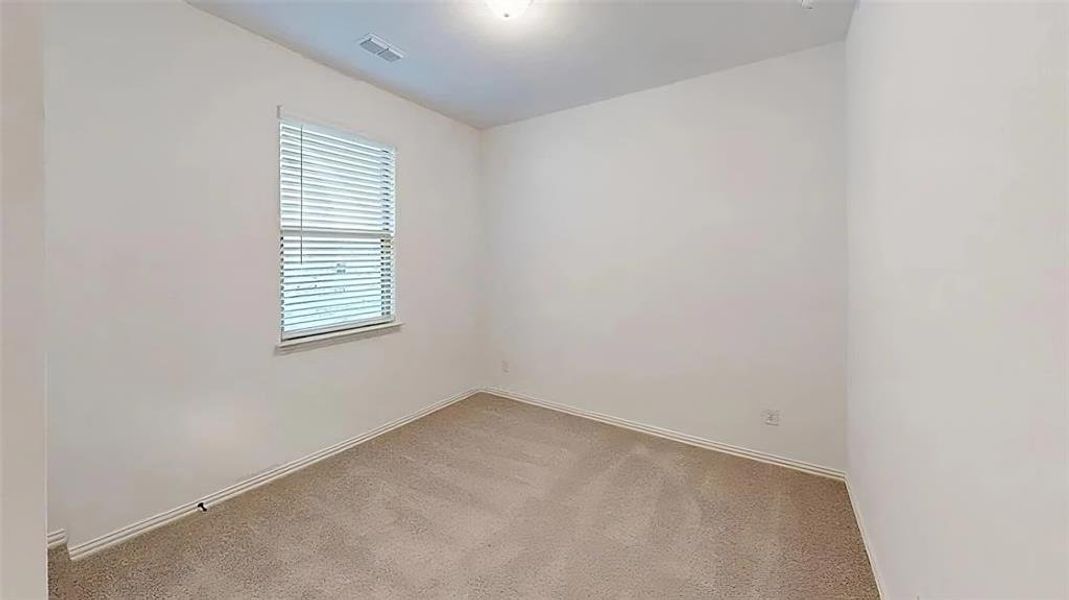 Empty room with light carpet and baseboards