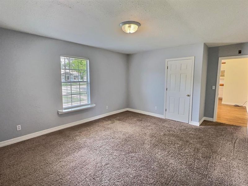 Unfurnished bedroom with carpet and a textured ceiling