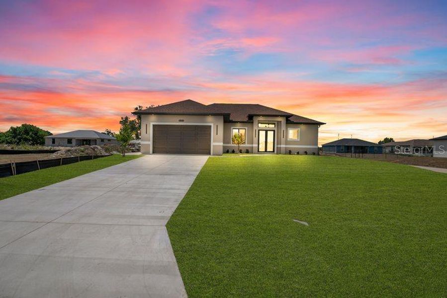 Front exterior of a new home in , Lehigh Acres, FL, highlighting curb appeal (Image 21).