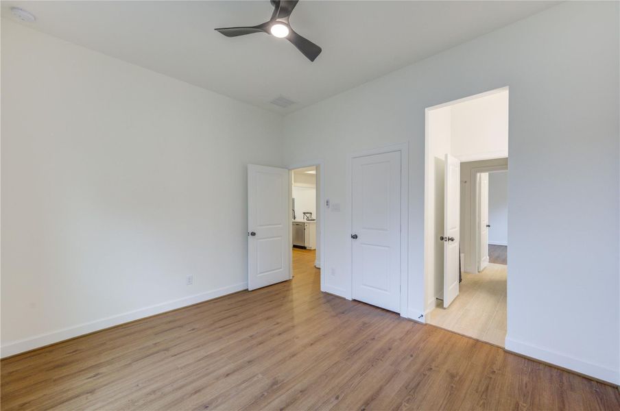 Discover a bright, airy bedroom with sleek hardwood floors, modern ceiling fan, and seamless access to adjacent rooms, creating a perfect blend of comfort and style. Discover a bright, airy bedroom with sleek hardwood floors, modern ceiling fan, and seamless access to adjacent rooms, creating a perfect blend of comfort and style.