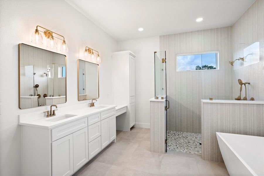 Bathroom with a shower stall, a freestanding bath, double vanity, light tile patterned flooring, and recessed lighting Bathroom with a shower stall, a freestanding bath, double vanity, light tile patterned flooring, and recessed lighting