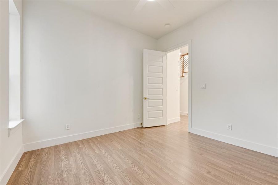 Empty room featuring light wood-style flooring and ceiling fan Empty room featuring light wood-style flooring and ceiling fan