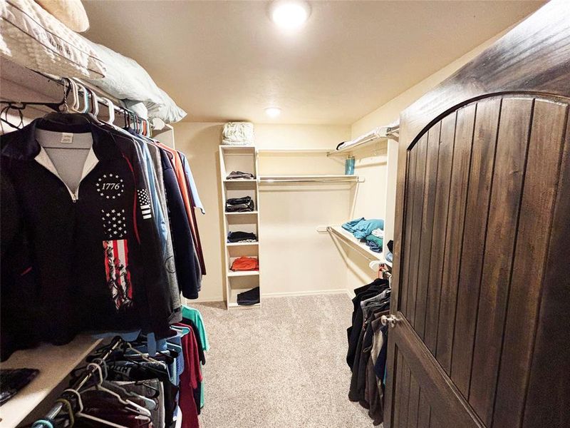 Spacious closet with light carpet Spacious closet with light carpet