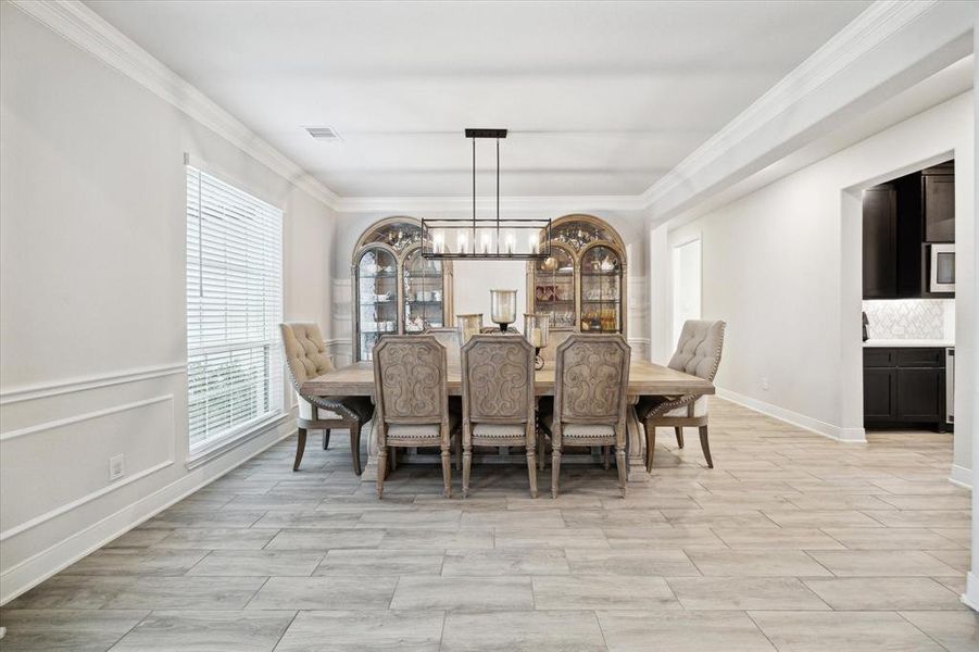 This inviting entry way dining room has plenty of room for all of your large gatherings.