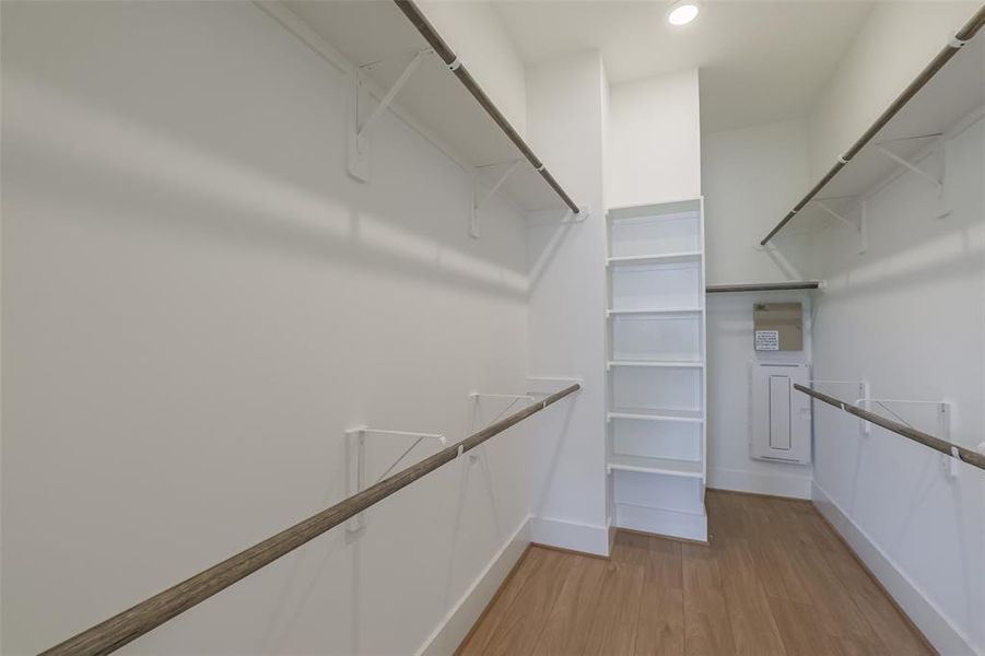 Large walk in closet with built in shelves.