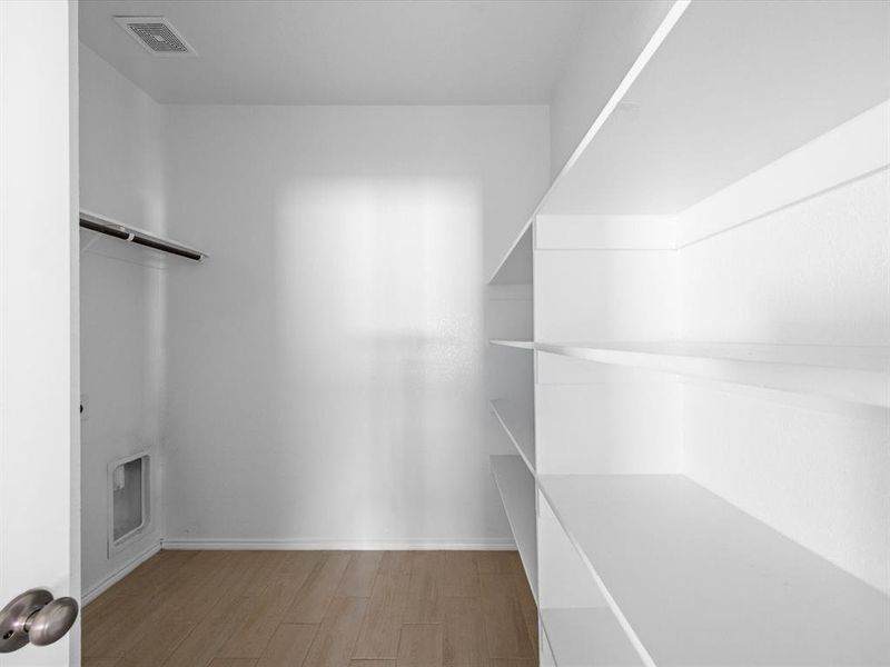 Walk in closet featuring light wood finished floors Walk in closet featuring light wood finished floors