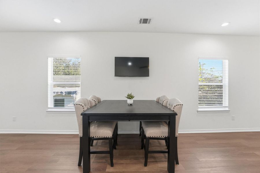A dedicated dining area provides a comfortable setting for meals or work-from-home flexibility, positioned perfectly within the open floor plan.