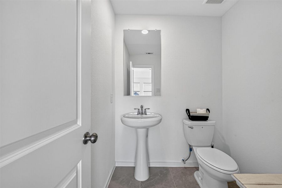 Convenient half bath located next to the game room. Convenient half bath located next to the game room.