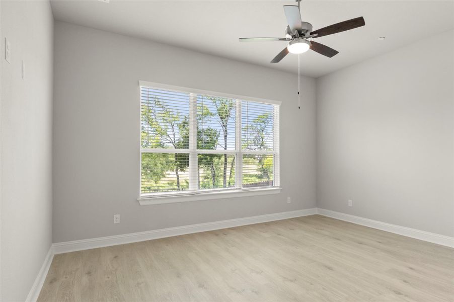 Unfurnished room featuring light wood finished floors and ceiling fan Unfurnished room featuring light wood finished floors and ceiling fan