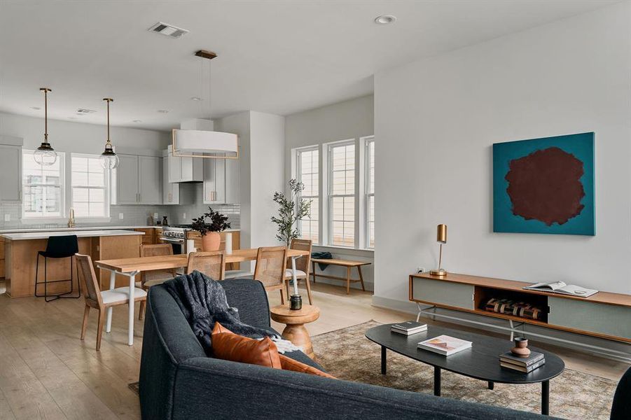 Open-concept living space featuring wood-finish flooring Open-concept living space featuring wood-finish flooring