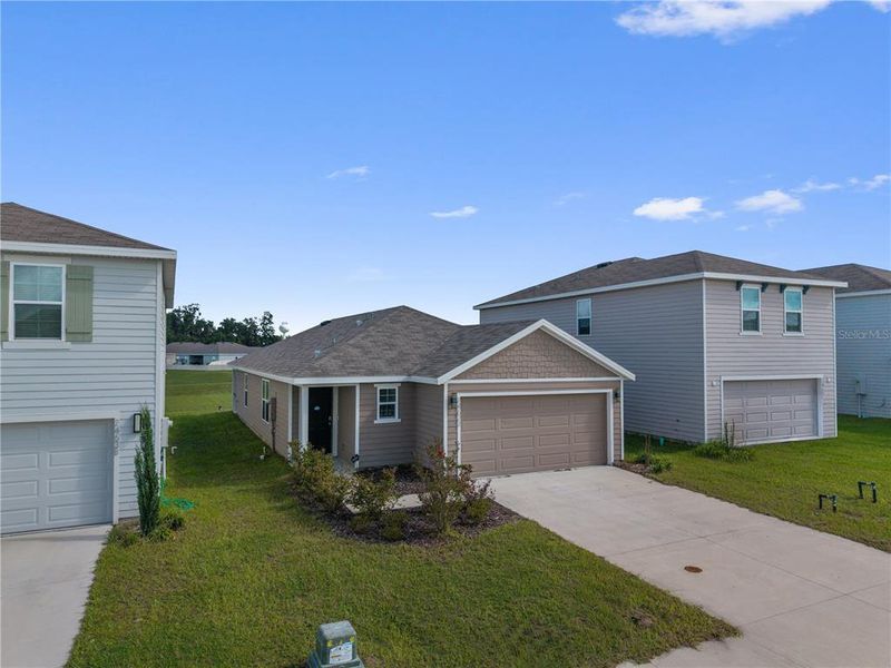 Front exterior of a new home in Avalon Woods, Newberry, FL, highlighting curb appeal (Image 26).