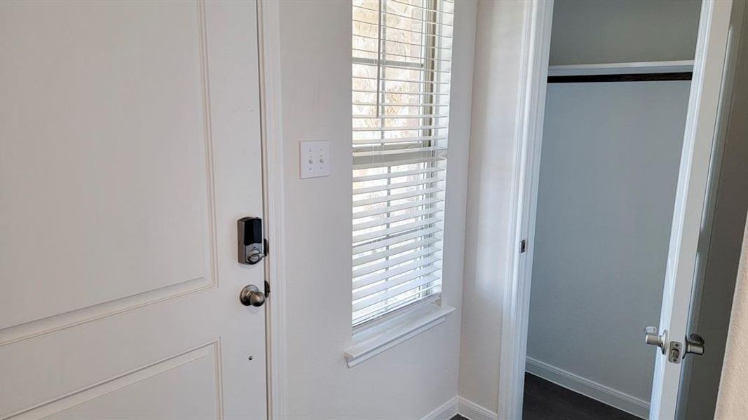 Entryway featuring baseboards and wood finished floors Entryway featuring baseboards and wood finished floors