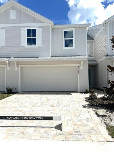 Front exterior of a new home in Cyrene at Harmony, St. Cloud, FL, highlighting curb appeal (Image 1).