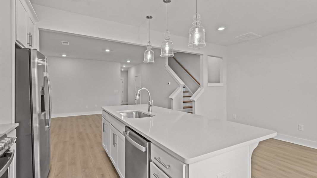 Exclusive DRB Homes kitchen with a 9-foot island, elevated finishes, and pendant lighting in a prime location