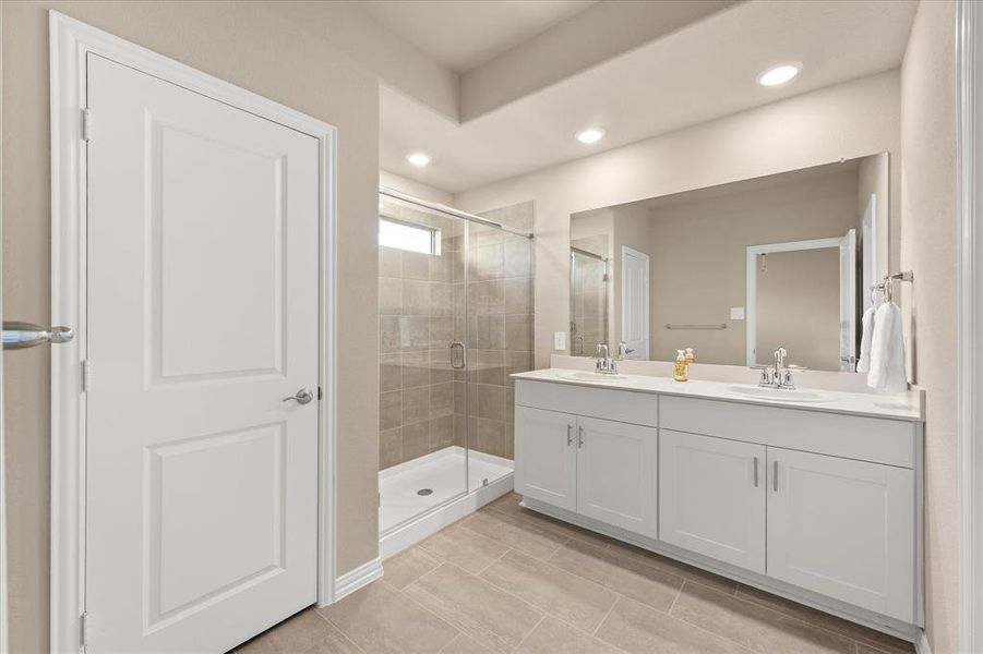 Full bath with a shower stall, double vanity, recessed lighting, and light tile patterned floors Full bath with a shower stall, double vanity, recessed lighting, and light tile patterned floors
