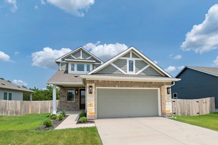 Front exterior of a new home in Grande Estates, Bertram, TX, highlighting curb appeal (Image 27). Front exterior of a new home in Grande Estates, Bertram, TX, highlighting curb appeal (Image 27).
