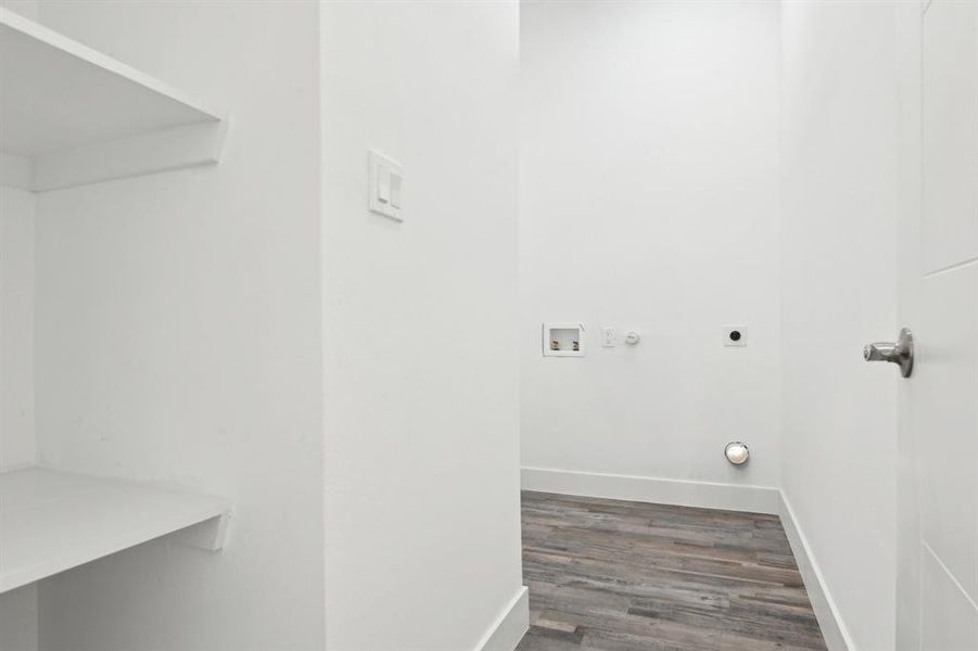 Clothes washing area featuring laundry area, baseboards, wood finished floors, washer hookup, and electric dryer hookup